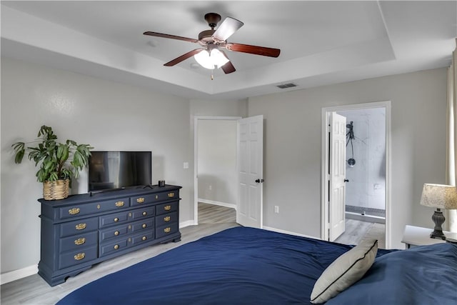 1119 Imperial St, Portland, TX 78374 - bedroom with a raised ceiling, baseboards, light wood-type flooring, a ceiling fan, and ensuite bathroom
