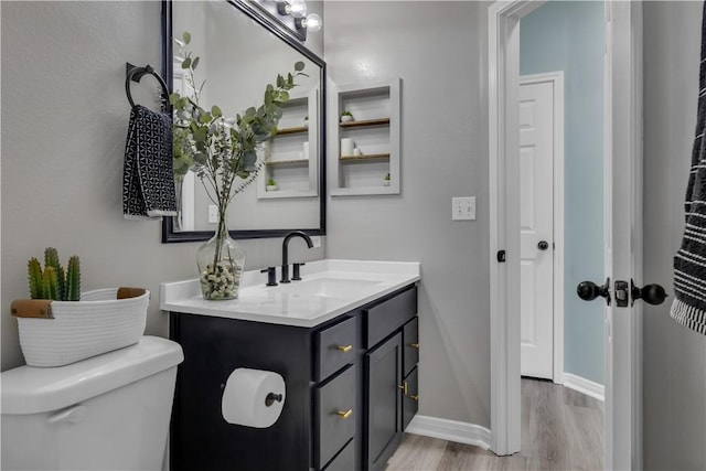 1119 Imperial St, Portland, TX 78374 - half bath with wood finished floors, vanity, toilet, and baseboards