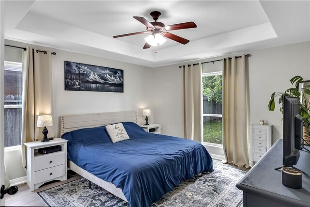 1119 Imperial St, Portland, TX 78374 - bedroom featuring a raised ceiling, light wood-style flooring, and ceiling fan