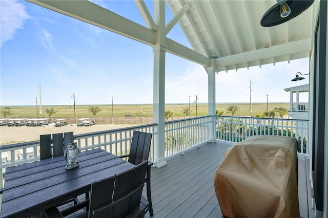 wooden terrace featuring a view of rural / pastoral area
