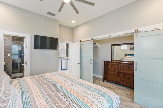 bedroom featuring a barn door, light wood-type flooring, recessed lighting, multiple windows, and ceiling fan