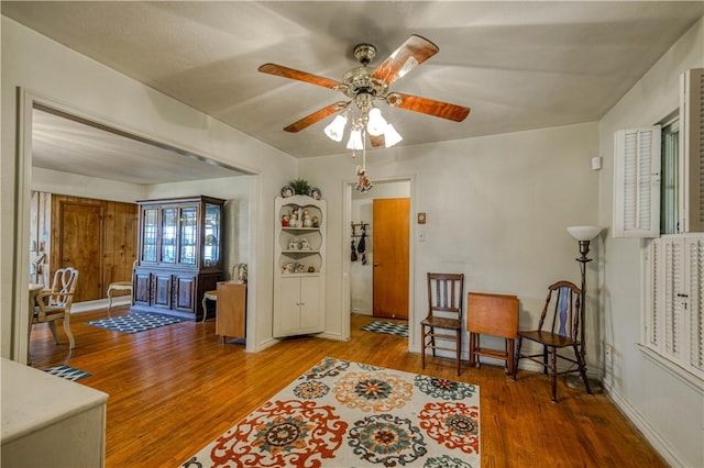 sitting room featuring hardwood / wood-style floors and ceiling fan