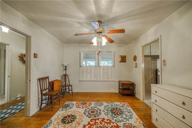 sitting room featuring light hardwood / wood-style floors and ceiling fan