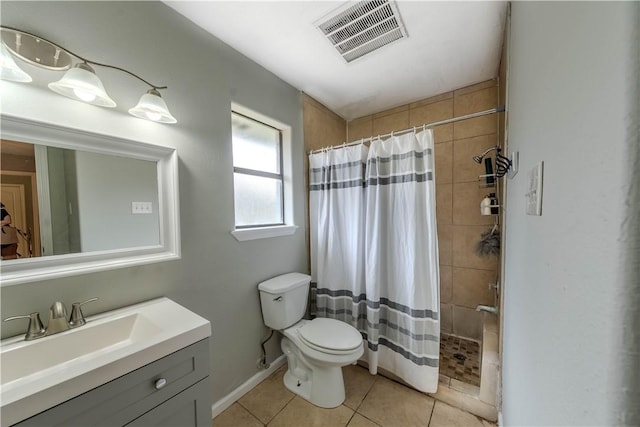 5929 Choctaw Dr, Corpus Christi, TX 78415 - full bath with tile patterned floors, toilet, tiled shower, vanity, and baseboards