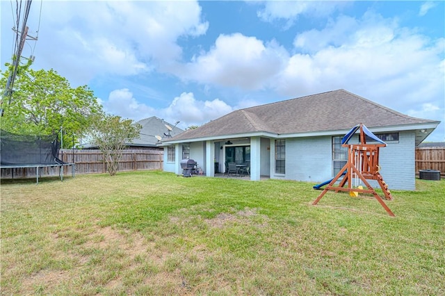 5929 Choctaw Dr, Corpus Christi, TX 78415 - rear view of house with a trampoline, a playground, a patio area, a shingled roof, and cooling unit