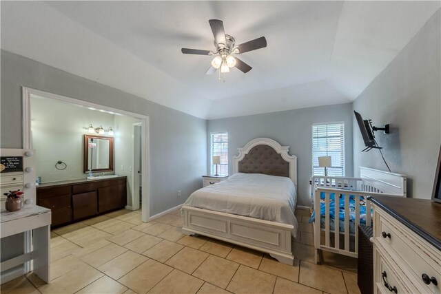 5929 Choctaw Dr, Corpus Christi, TX 78415 - bedroom with a tray ceiling, light tile patterned flooring, ensuite bathroom, and baseboards
