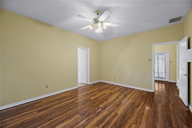 spare room with ceiling fan, dark wood-type flooring, and a textured ceiling