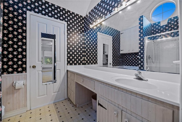 bathroom with vanity and a shower