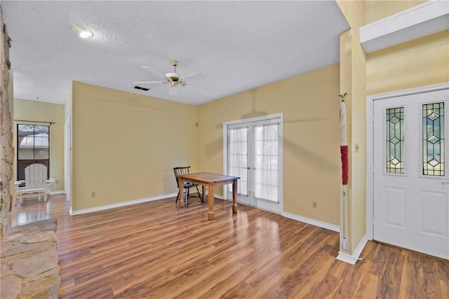 entrance foyer with hardwood / wood-style floors, french doors, and a textured ceiling