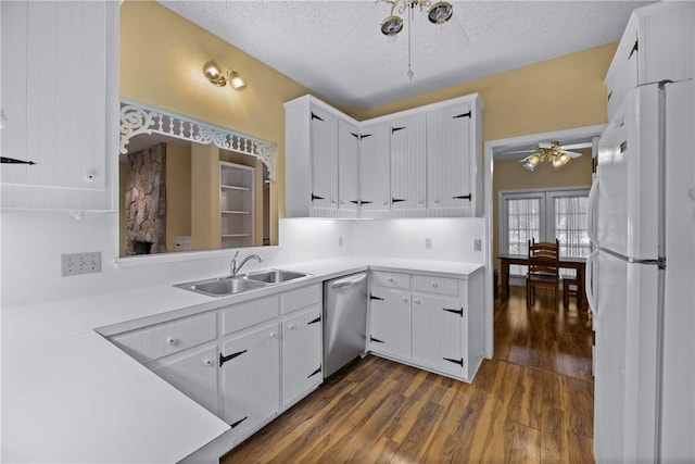 kitchen with sink, white cabinetry, stainless steel dishwasher, white fridge, and ceiling fan