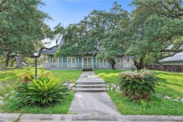 view of front of house featuring french doors and a front lawn