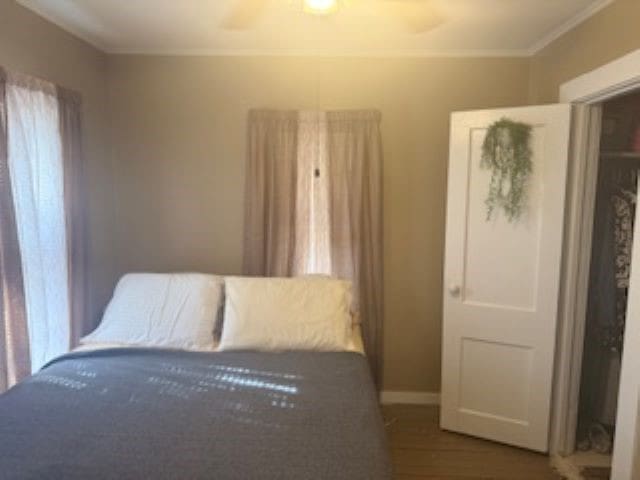 bedroom featuring dark hardwood / wood-style flooring and ornamental molding