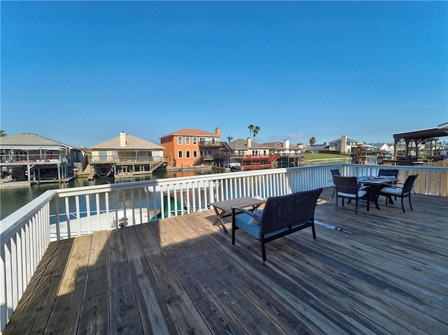 wooden terrace featuring a water view