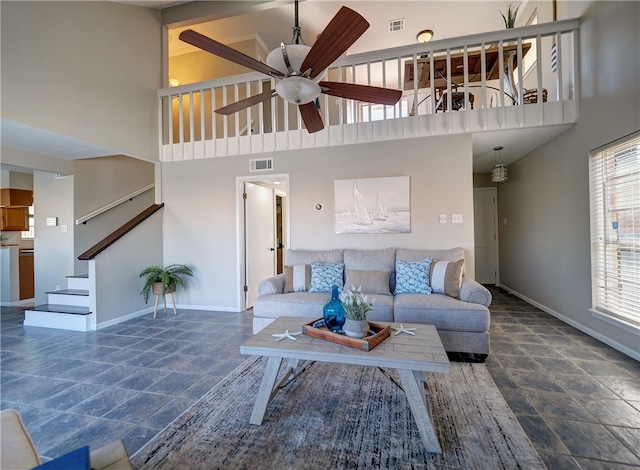 living room with ceiling fan and high vaulted ceiling