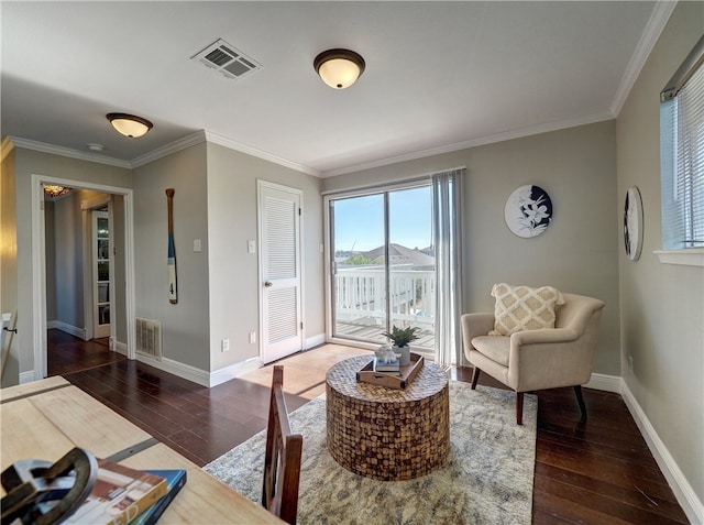 living area featuring dark hardwood / wood-style flooring and crown molding