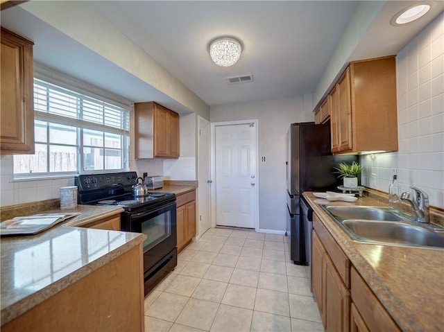 kitchen featuring backsplash, sink, black electric range oven, and light tile patterned floors