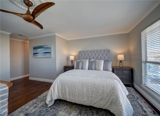 bedroom with dark hardwood / wood-style flooring, ceiling fan, and crown molding