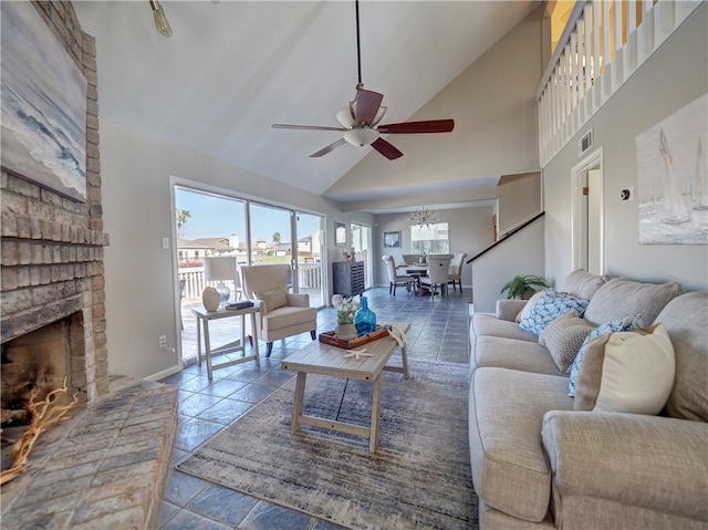 living room featuring high vaulted ceiling, a fireplace, and ceiling fan