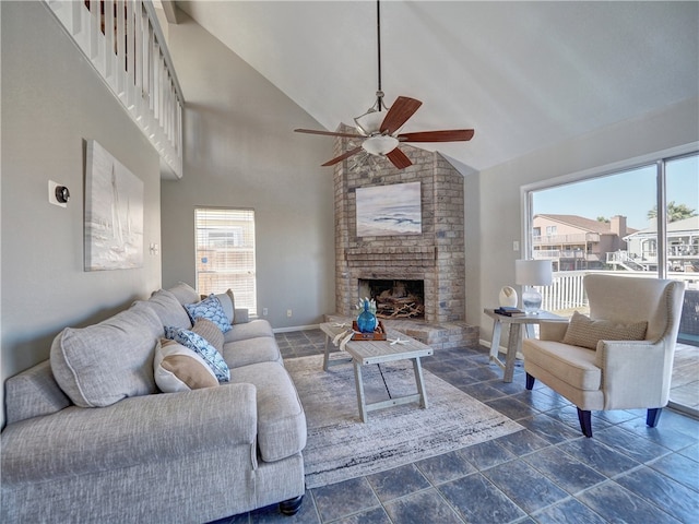 living room featuring high vaulted ceiling, a wealth of natural light, ceiling fan, and a fireplace