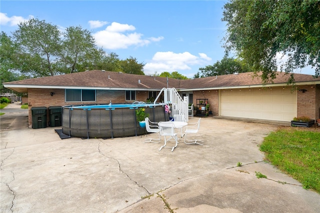 rear view of property with a garage