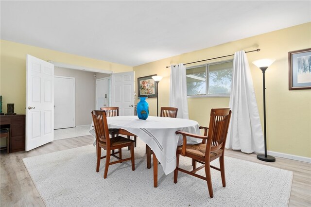 dining area with light hardwood / wood-style flooring