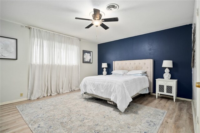 bedroom featuring hardwood / wood-style floors and ceiling fan