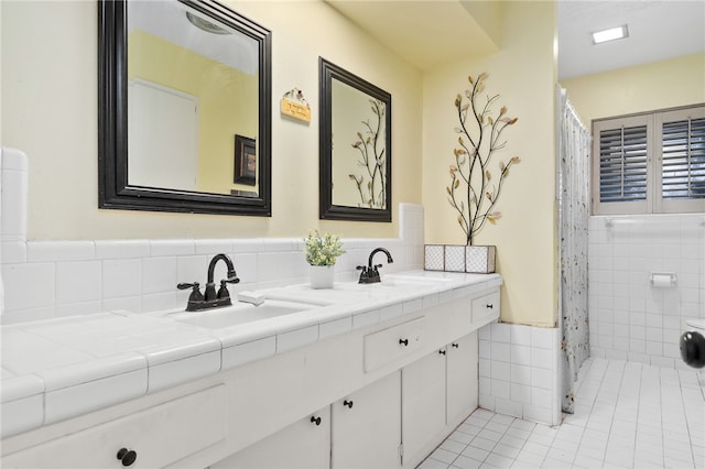 bathroom featuring vanity, tile patterned flooring, and tile walls