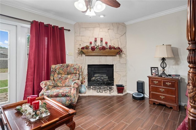 living room featuring a ceiling fan, crown molding, and plenty of natural light