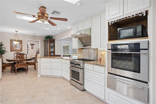kitchen featuring light stone countertops, stainless steel appliances, a warming drawer, visible vents, and white cabinetry