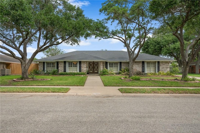 ranch-style house with a front lawn