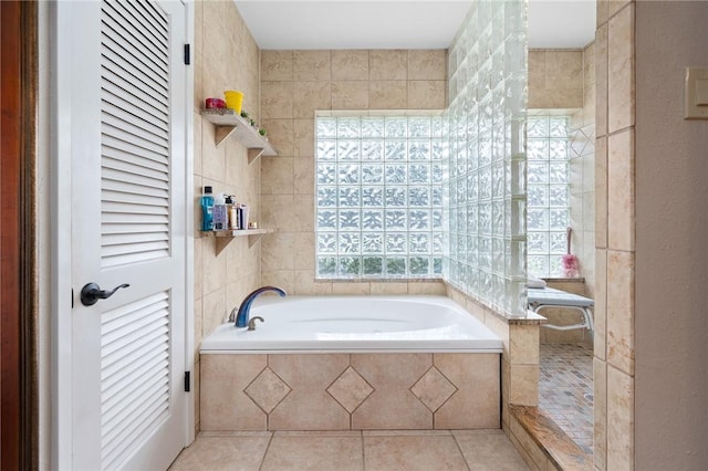 bathroom with tile walls, a tile shower, a garden tub, and tile patterned flooring