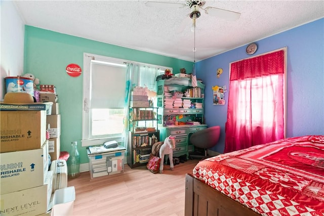 117 Doyle Dr, Portland, TX 78374 - bedroom with wood finished floors, a textured ceiling, and a ceiling fan