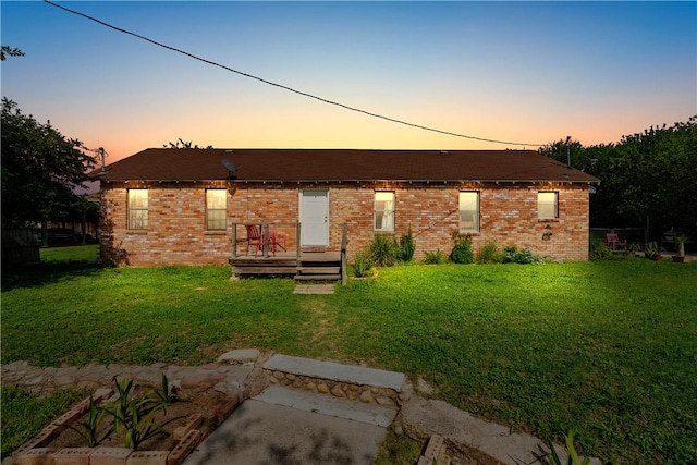 117 Doyle Dr, Portland, TX 78374 - back of property at dusk with a yard and brick siding