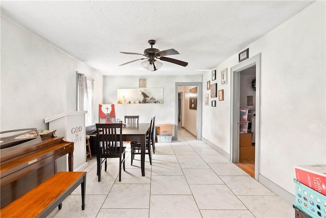117 Doyle Dr, Portland, TX 78374 - dining space with a ceiling fan, a textured ceiling, and light marble finish floors
