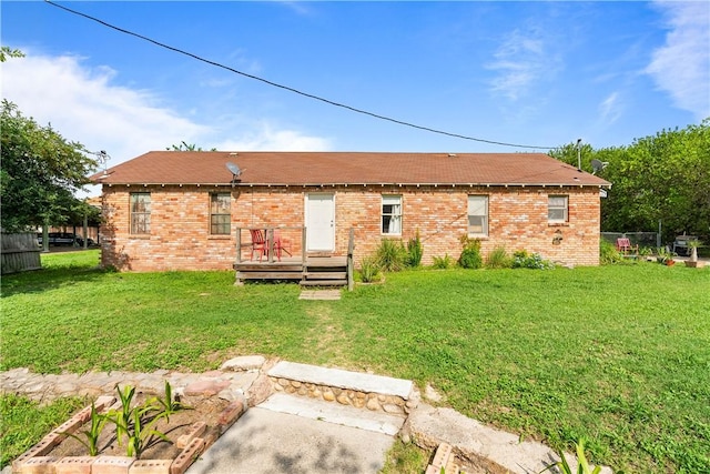 117 Doyle Dr, Portland, TX 78374 - back of property featuring a yard, a wooden deck, and brick siding