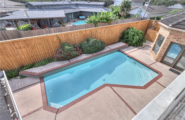 view of swimming pool featuring a patio area