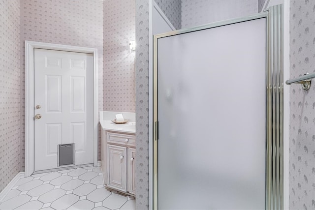 bathroom with vanity and a shower with shower door