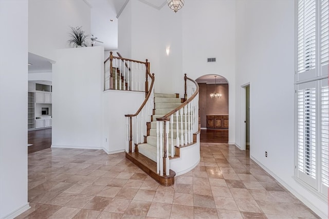 entryway with a notable chandelier and a high ceiling