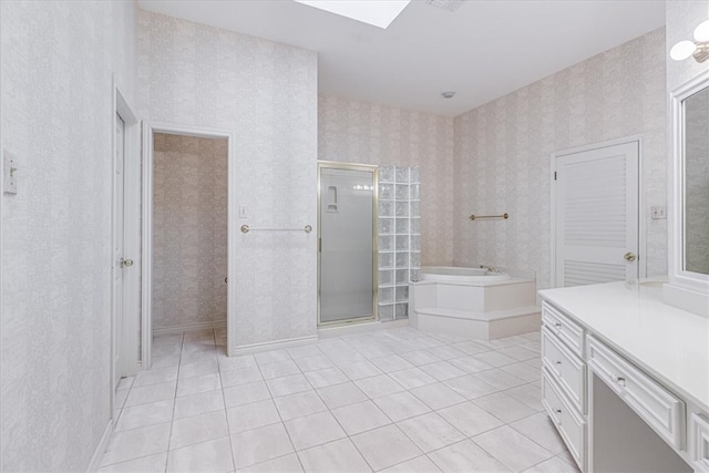 bathroom with vanity, shower with separate bathtub, and tile patterned floors