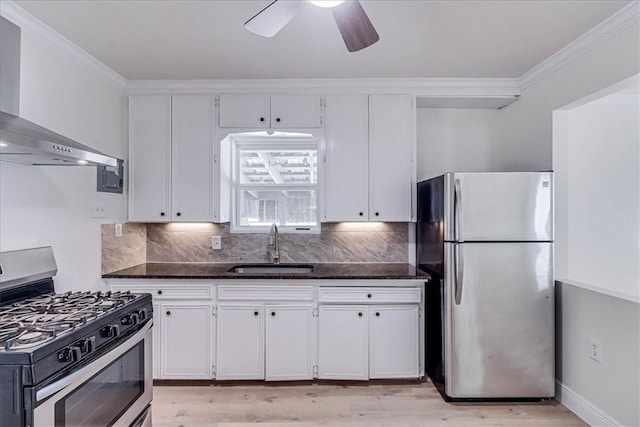 kitchen featuring a sink, white cabinets, wall chimney exhaust hood, and stainless steel appliances