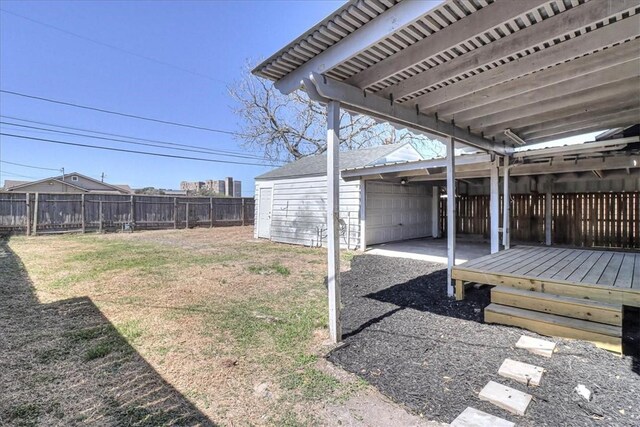 view of yard featuring an outdoor structure and fence