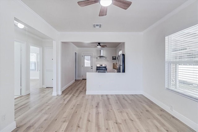 unfurnished living room featuring visible vents, a healthy amount of sunlight, and ornamental molding