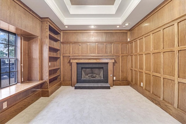 living room featuring a brick fireplace, light carpet, built in features, and wood walls