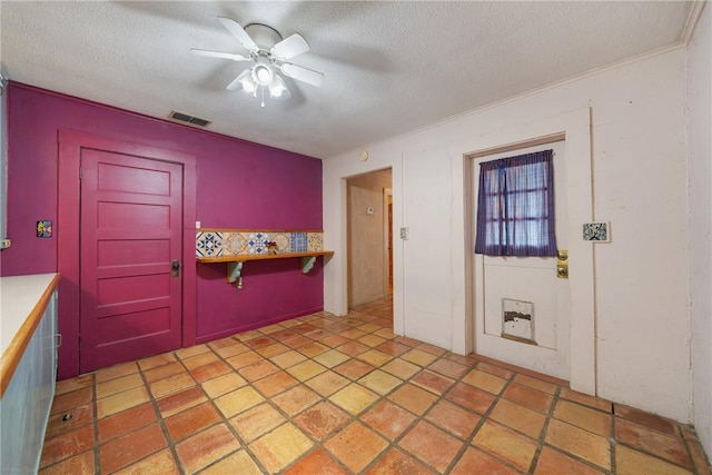 kitchen with ceiling fan and a textured ceiling