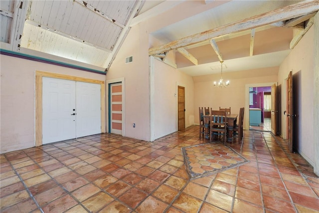 unfurnished dining area with beamed ceiling, high vaulted ceiling, a chandelier, and track lighting