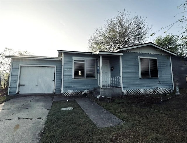 view of front of home featuring concrete driveway and a garage