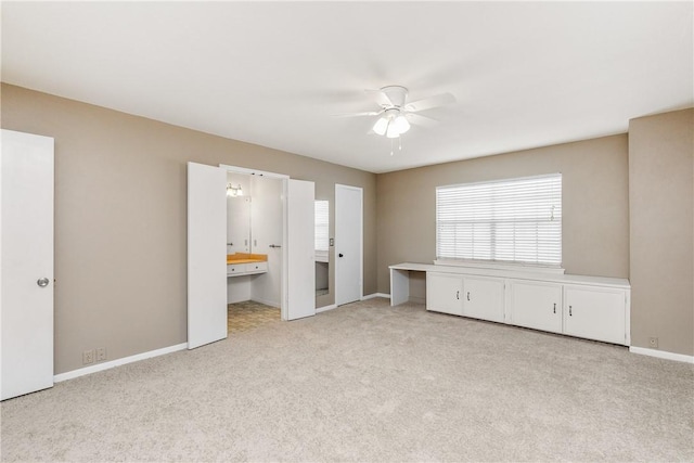 41 Townhouse, Corpus Christi, TX 78412 - unfurnished bedroom featuring light carpet, baseboards, ensuite bath, and a ceiling fan