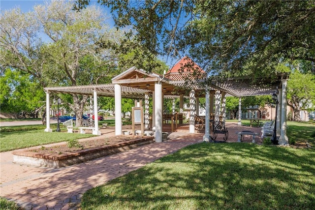 surrounding community featuring a pergola and a yard