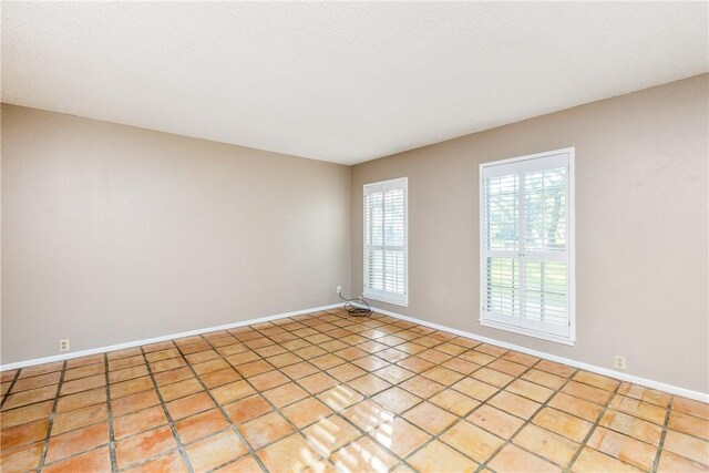 41 Townhouse, Corpus Christi, TX 78412 - empty room with baseboards and light tile patterned floors