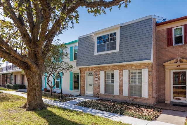 41 Townhouse, Corpus Christi, TX 78412 - townhome / multi-family property featuring roof with shingles, mansard roof, and brick siding